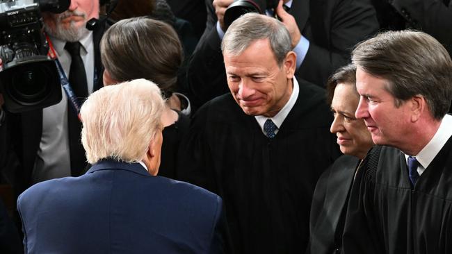 US President Donald Trump greets Supreme Court Chief Justice John Roberts after giving an address to a joint session of Congress on March 4. Picture: AFP