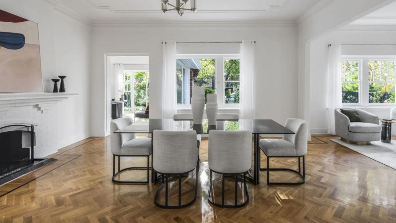 A marble-tiled entryway leads to living and dining space with a fireplace.