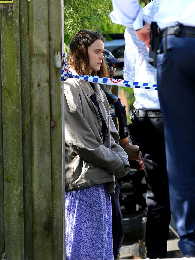 A woman at the scene of a Yugar home where a baby was found dead. Picture: David Clark