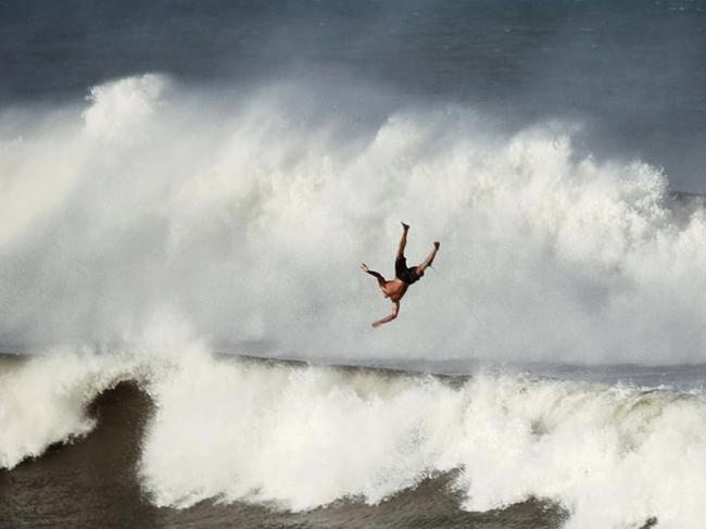 Mum captures iconic ‘falling man’ photo in wild Alfred surf