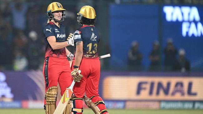 Royal Challengers Bangalore's Richa Ghosh (R) celebrates with Ellyse Perry. Picture: Sajjad Hussain/AFP