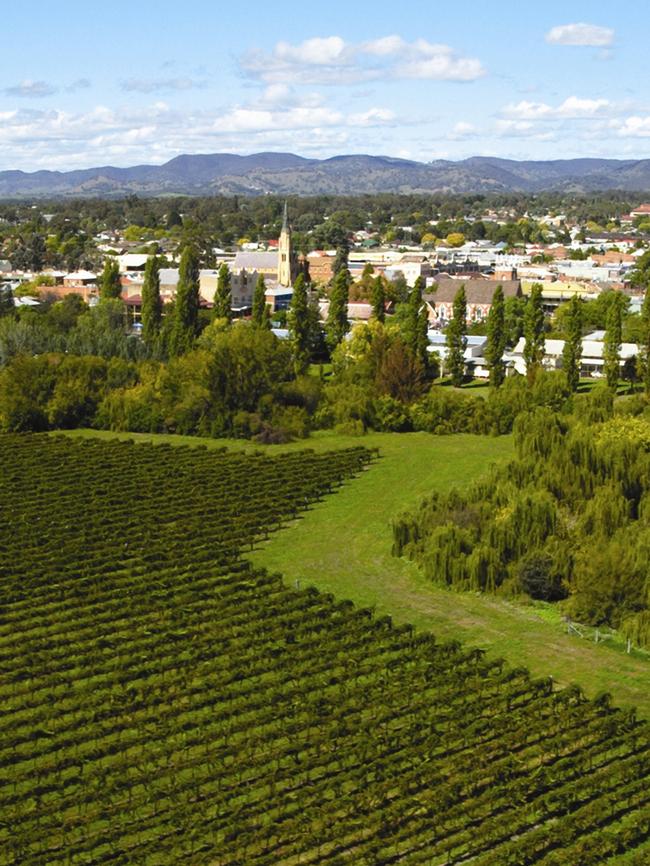 Aerial view of the town of Mudgee, NSW, with wine vineyards in foreground.