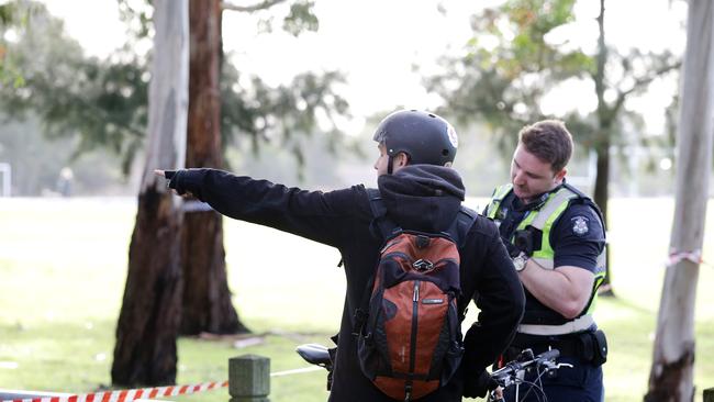 Witnesses helping police at the scene. Picture: Andrew Tauber