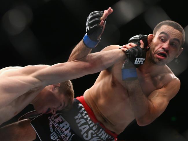 Jake Matthews connects with a right to Vagner Rocha in their lightweight fight during the UFC Fight Night 55 event at Allphones Arena