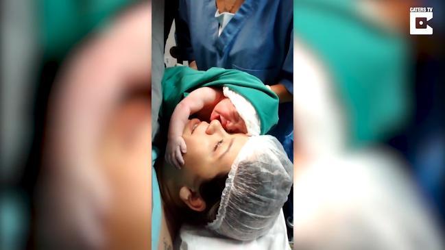 The emotional moment newborn baby clings to mum's face