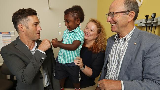 Plastic surgeon Jonathan Burge, neurosurgeon Alison Wray and cranofacial surgeon Tony Holmes with their young patient. Picture: Alex Coppel