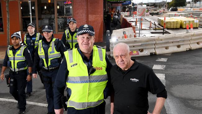 Senior Sergeant Michael Lamb with Lucky Ferraro and other police officers in Young St. Picture: Penny Stephens