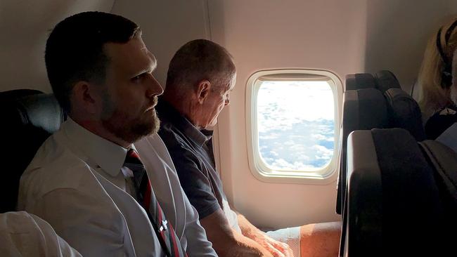 Chris Dawson is escorted by NSW Police on a flight from Queensland to NSW to face charges of murder over the death of his wife Lyn Dawson. Picture: Lyndon Mechielsen