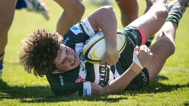 Warringah player Riley Whitfield in the battle with Sydney Uni.
