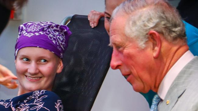 Britain's Prince Charles sits with Abbi Head, 13 (left) of Brisbane during his official visit to the Lady Cilento Children's Hospital in Brisbane, Wednesday, April 4, 2018. The 2018 Gold Coast Commonwealth Games will be officially opened by HRH Charles at Carrara Stadium later this evening. (AAP Image/AFP Pool/Patrick Hamilton)