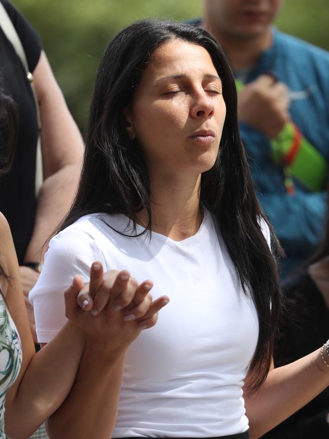 Leila Geagea, mother of three of the children killed in the Oatlands crash prays at the scene. Picture John Grainger