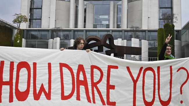 Environmentalists hold a banner reading "How dare you?", quoting Thunberg. Picture: Tobias SCHWARZ / AFP