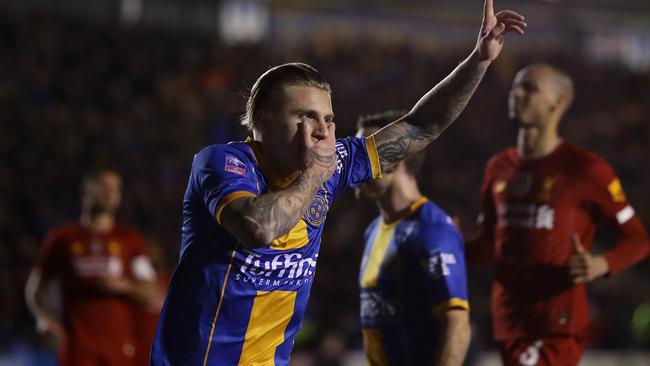 Jason Cummings celebrates after scoring Shrewsbury’s first goal.