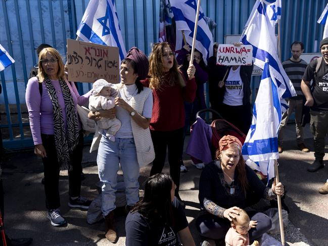 Right wing activists hold signs and flags as they block the entrance to the UNRWA branch during a protest against the organization in Jerusalem. Picture: Getty