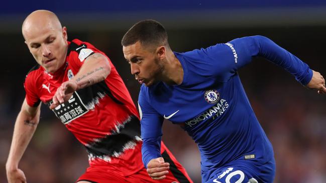 Aaron Mooy keeps a close eye on Chelsea dangerman Eden Hazard.