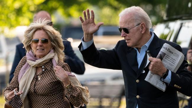 US President Joe Biden waves after removing his mask as he and US First Lady Jill Biden walk to Marine One. Picture: AFP