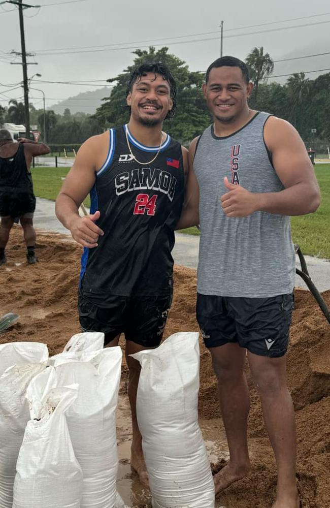 North Queensland Cowboys stars Jeremiah Nanai and Viliami Vailea help fill sandbags at Lou Litster Park during the Townsville flooding disaster, Saturday February 1, 2025. Photo: Taleena Baker