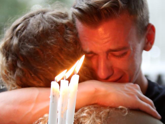 Brett Morian, from Daytona Beach, hugs an attendee during the candlelight vigil at Ember in Orlando, Fla., on Sunday, June 12, 2016. (Joshua Lim/Orlando Sentinel via AP)