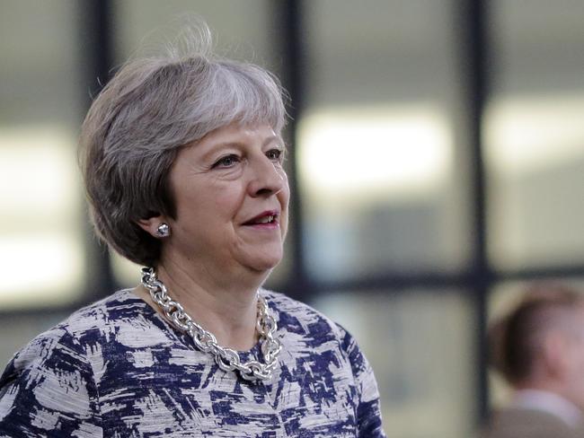 British Prime Minister Theresa May walks through the NATO headquarters prior to working session of a NATO a summit of heads of state and government in Brussels on Wednesday, July 11, 2018. (AP Photo/Markus Schreiber)