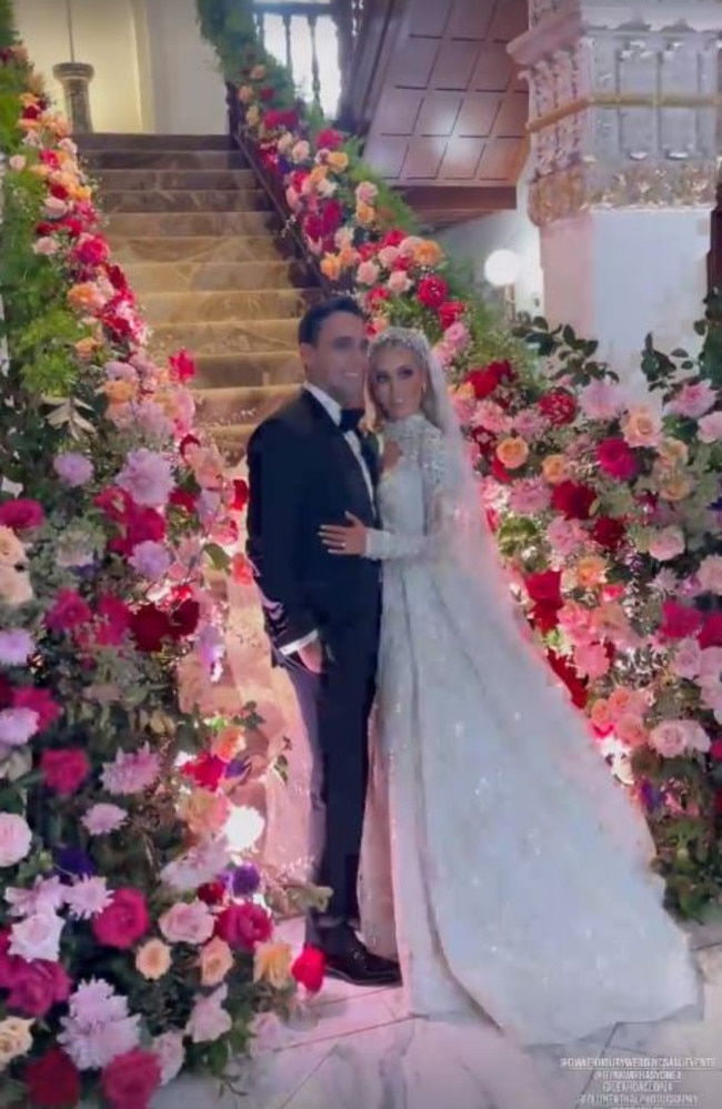 The happy couple posed for photos amid the lavish flower display.