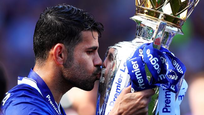 Diego Costa kisses the Premier League trophy.
