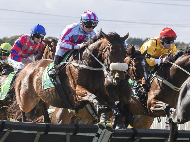 WARRNAMBOOL, AUSTRALIA - MAY 01: Luca Remondet riding Chains of Honour jumps hurdle on his way to win race 6, the Sovereign Resort Galleywood Hurdle during Galleywood Day at Warrnambool Racecourse on May 01, 2024 in Warrnambool, Australia. (Photo by Vince Caligiuri/Getty Images)