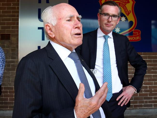 Former Prime Minister John Howard visits his old high school, Canterbury Boys High where the NSW state government will build an assembly hall which will be named after their most famous graduate. NSW Treasurer Dominic Perrottet (C) with Mr Howard. Picture: Toby Zerna