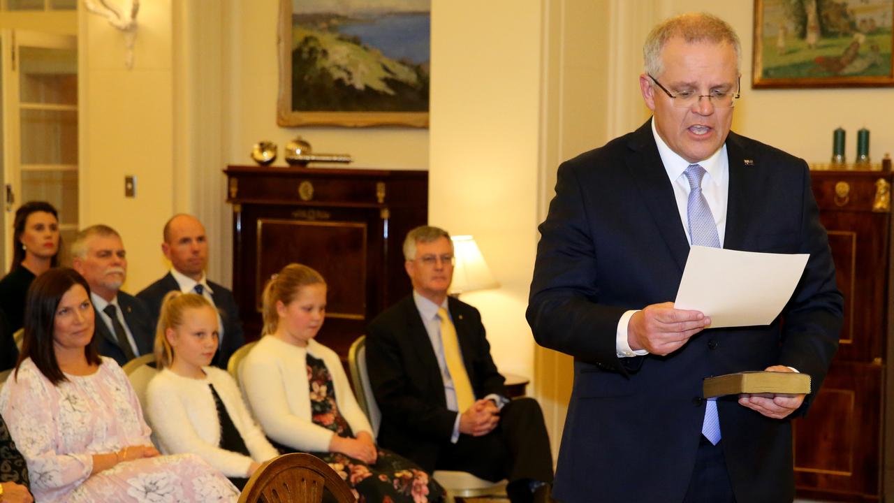 Scott Morrison held a bible and took an oath that ended with the words “so help me God”. Picture: Ray Strange.