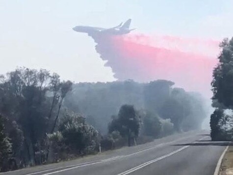 A plane drops a load of fire retardant at Peregian. Picture: Ronnie Stanton