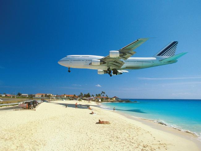 Plane coming in for landing on Maho Bay Beach, Saint Martin, Caribbean