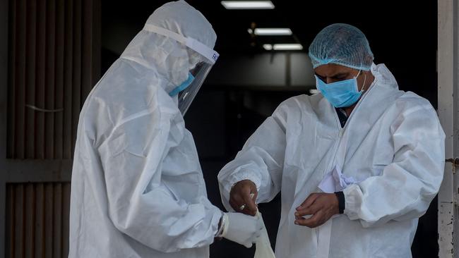 Health workers wear their PPE suits ahead of their respective duties outside a Covid-19 Coronavirus outpatient department. Picture: AFP