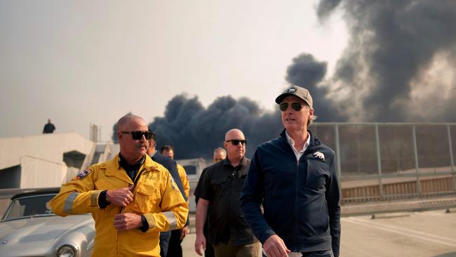 California Governor Gavin Newsom (right) tours the downtown business district of Pacific Palisades on Wednesday. Picture: Eric Thayer/Getty Images/AFP