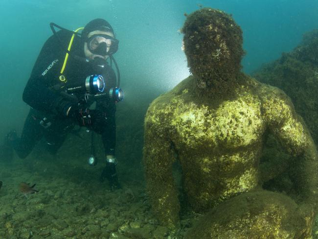 Scuba diver with statue depicting a companion of Ulysses (perhaps Baio), located in the submerged Nymphaeum of Emperor Claudius, near Punta Epitaffio, Marine Protected Area of Baia, Naples, Italy, Tyrrhenian Sea (Photo by Franco Banfi / Biosphoto / Biosphoto via AFP)