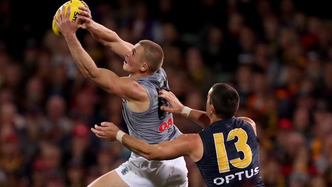 Tom Clurey of the Power outmarks Taylor Walker of the Crows on Saturday. Picture: James Elsby/AFL Photos via Getty Images