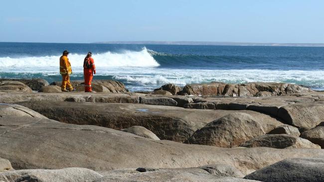 Streaky Bay SES search the rocky coastline at Granites Rock for the remains of a shark attack victim. Picture: Andrew Brooks