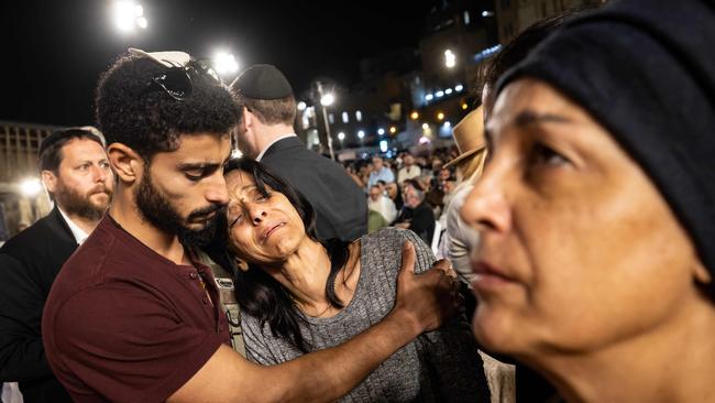 People react after lighting candles at the Western Wall in Jerusalem on November 6, in memory of the 1400 victims killed during the Hamas attack. Picture: AFP