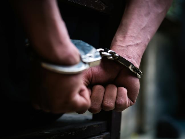 Man on the chair in Handcuffs. Rear view and Closeup ,Men criminal in handcuffs arrested for crimes. With hands in back,boy  prison shackle in the jail violence concept. - istock