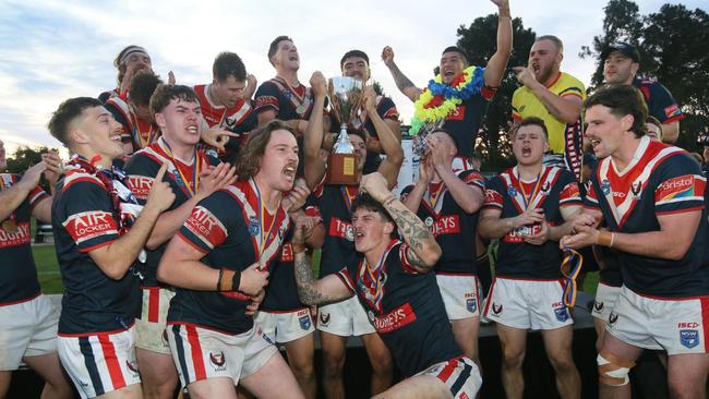 Erina players celebrate with the trophy. Picture: Sue Graham