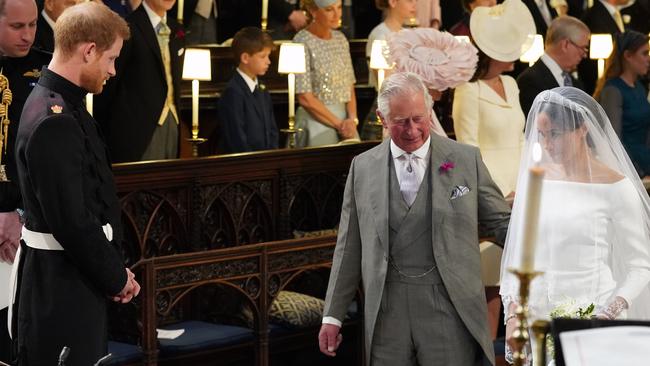 Prince Charles escorts Meghan down the aisle. Picture: Jonathan Brady