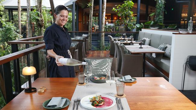 Food and beverage attendant Brooke Paul pours a glass of wine at Silky Oaks Lodge at Finlayvale, north of Mossman. Picture: Brendan Radke