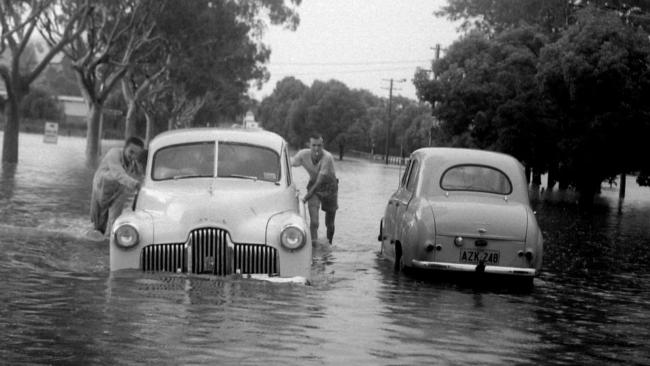 Historic: Lismore: Floods 1954 Men retrieve a car from the flooded streets of Lismore in the 1954 flood. Photo The Northern Star Archives