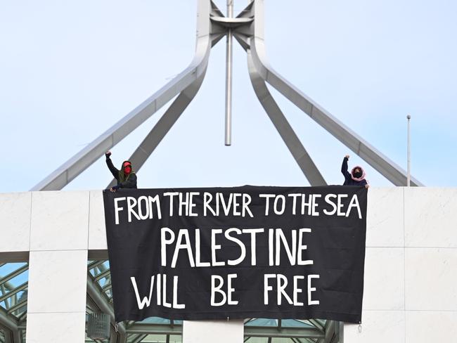 The ugly message unfurled by activists at Parliament House is one that is regurgitated constantly from politicians to celebrities to corporate virtue signallers. Picture: Martin Ollman