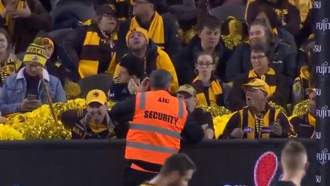 A security guard speaking to a member of the Hawthorn cheer squad at Marvel Stadium on Friday night. Picture: Channel 7