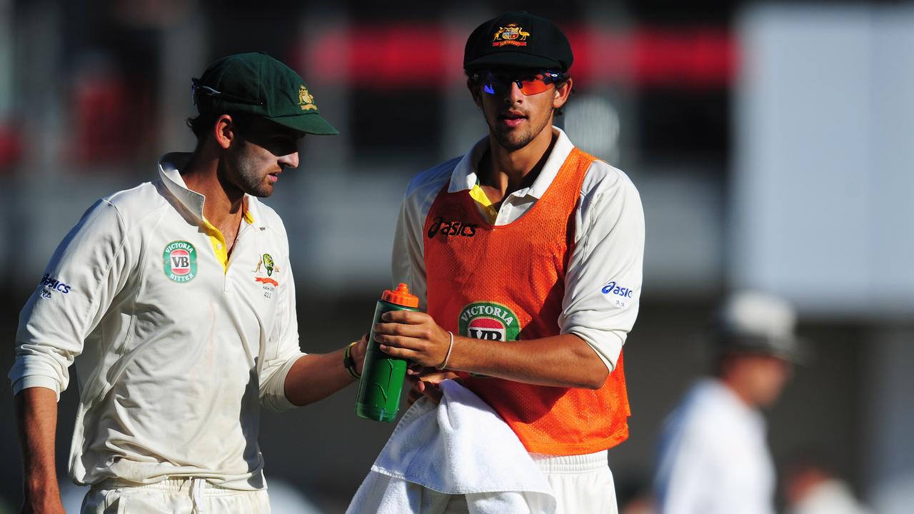 MANCHESTER, ENGLAND - AUGUST 02: Nathan Lyon (L) of Australia is given a drink by Ashton Agar during day two of the 3rd Investec Ashes Test match between England and Australia at Emirates Old Trafford Cricket Ground on August 2, 2013 in Manchester, England. (Photo by Stu Forster/Getty Images)