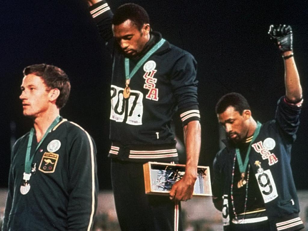 Sprinter Peter Norman (left) holds the record for the fastest ever Australian 200m sprint. Picture: AP Photo/file