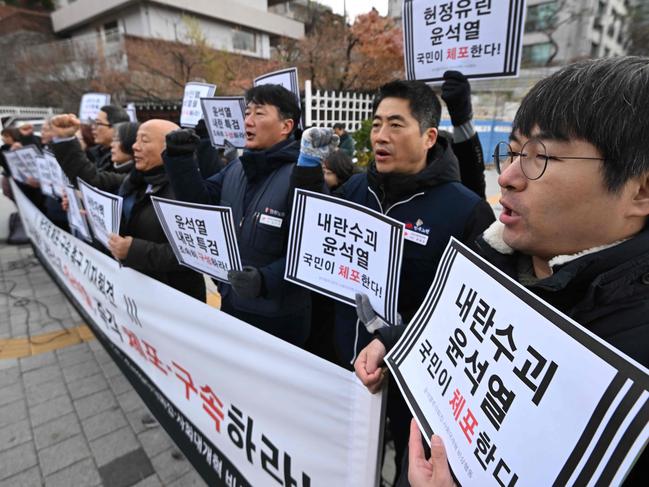 Protesters hold placards reading "Arrest Insurrectionist Yoon Suk Yeol!" during a demonstration calling for the ouster of South Korea President Yoon Suk Yeol near the presidential residence in Seoul. Picture: AFP