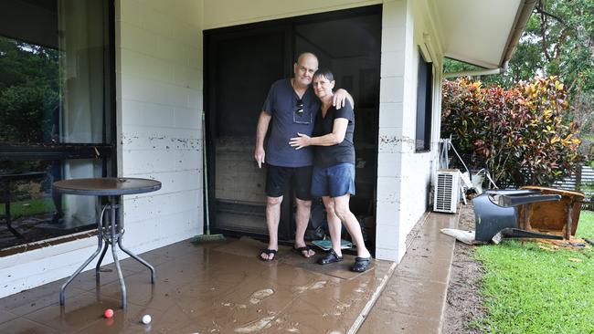 Ted and Pam Fay surveying their home in the aftermath of the flood. Picture: Brendan Radke