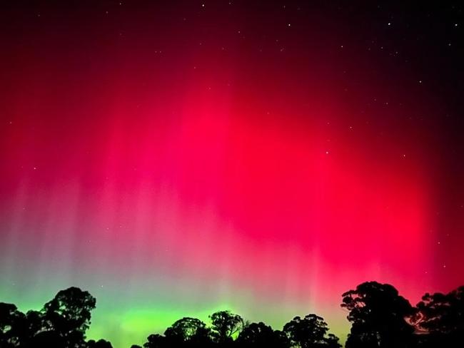 The dazzling pink and green southern lights spectacle was visible in Sugarloaf Creek during the May aurora australis event. Picture: Remi Lezon