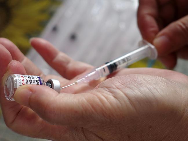 A health worker prepares a dose of Pfizer COVID-19 coronavirus vaccine at a health center in Jakarta on February 1, 2023. (Photo by BAY ISMOYO / AFP)