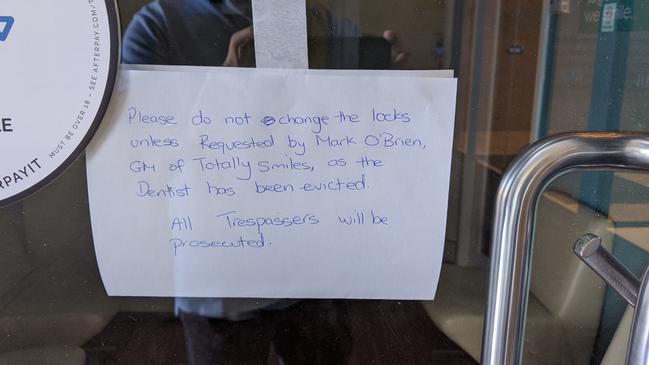 One of the notes taped to the Smiles Inclusive dental surgery doors. Picture: Supplied